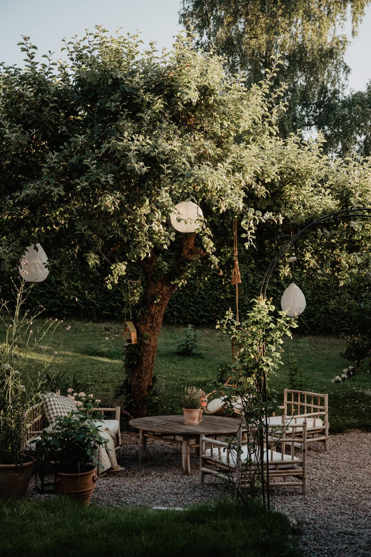 Emelie Sundberg home tour -garden of a Swedish home with outdoor seating area