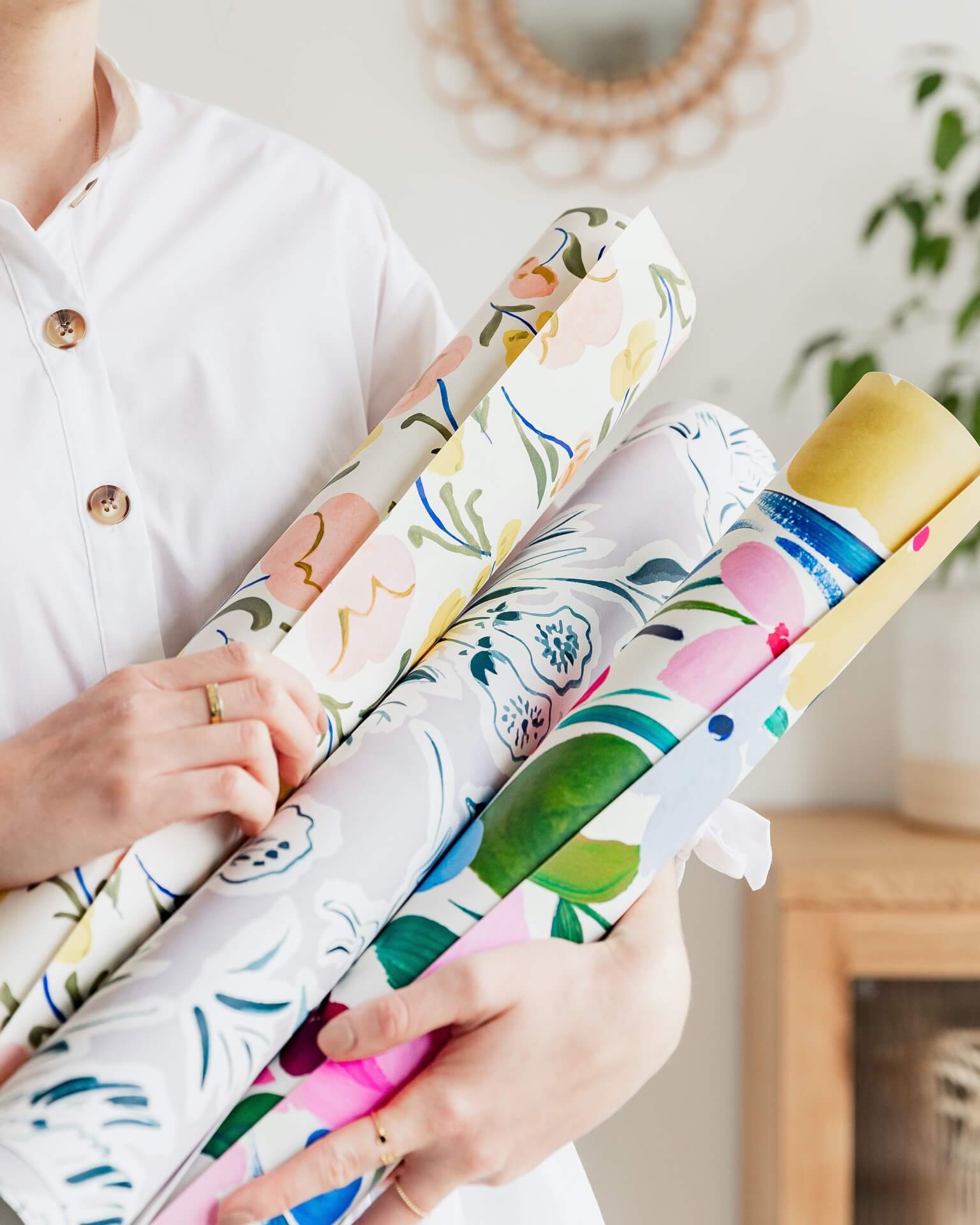 rolls of illustrated patterned wallpapers by Minibeau