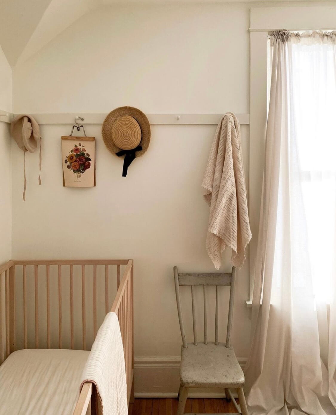 corner of a neutral child's bedroom, with vintage decor details