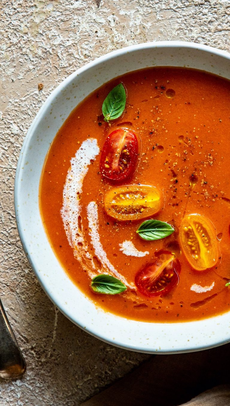 Recipe for roasted tomato soup, garnished with cherry tomatoes and basil