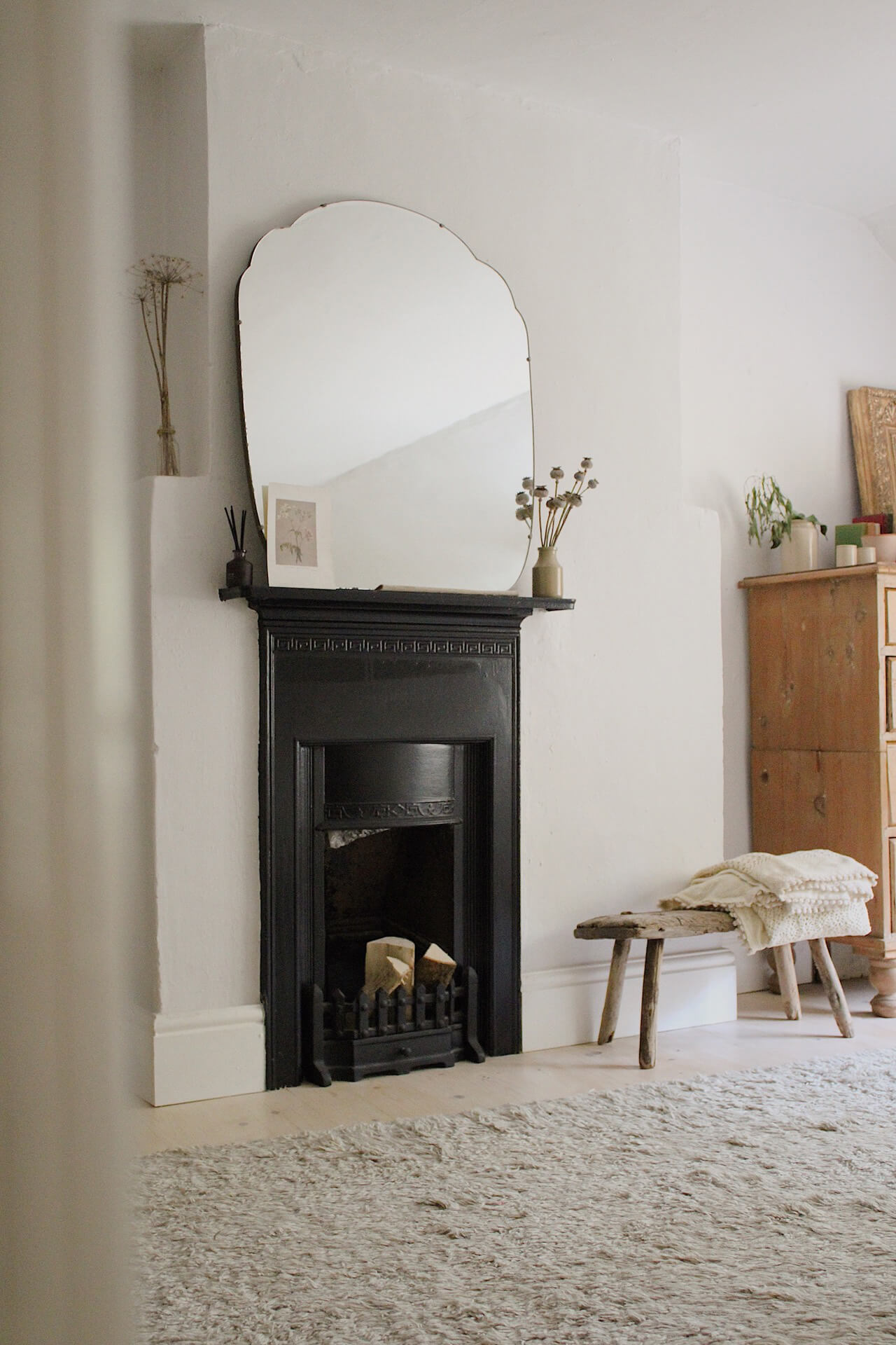 Home tour with Rachel Ashfield of @the_old_cottage - an old fireplace in a muted, calming bedroom