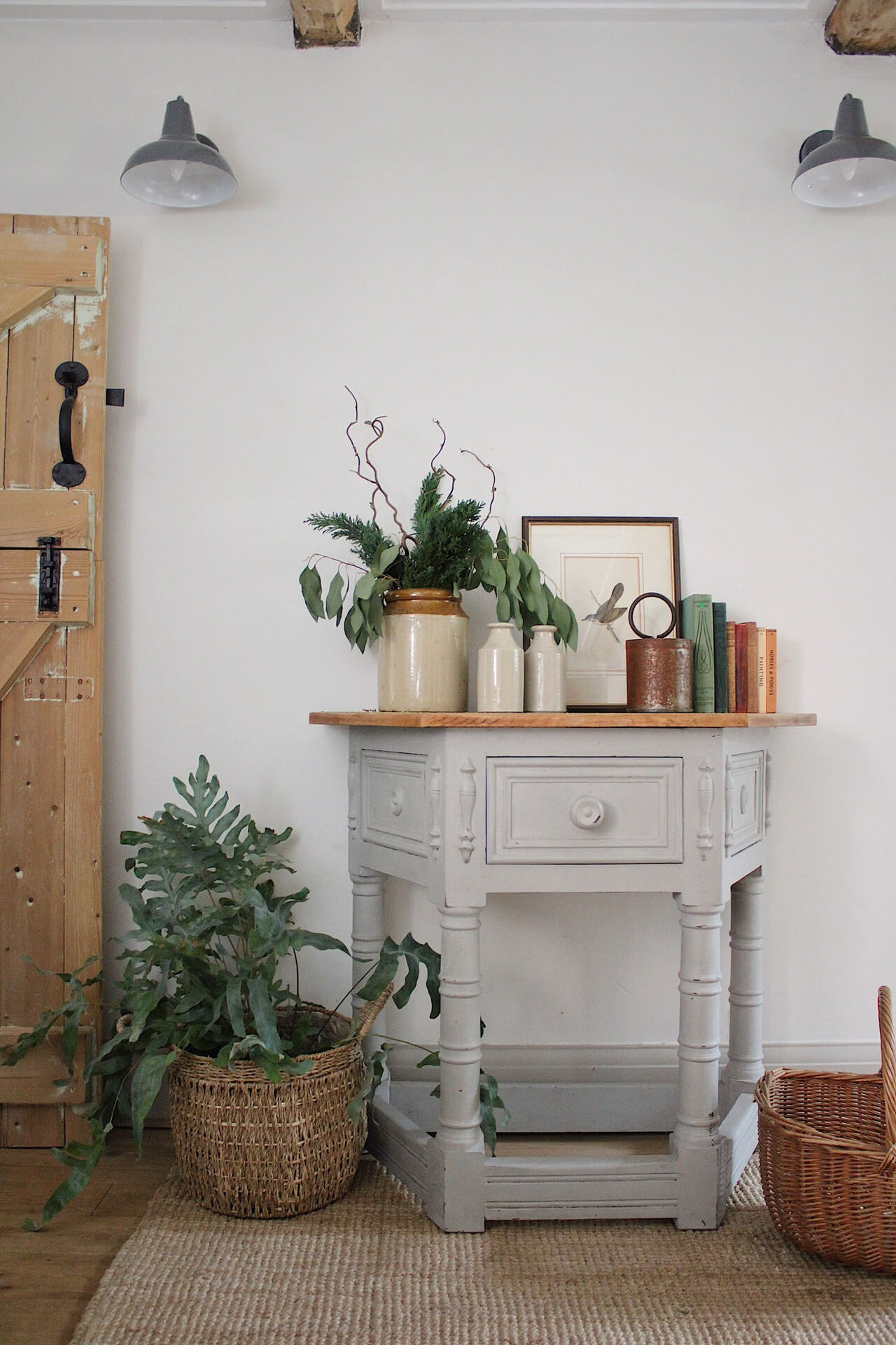 Home tour with Rachel Ashfield of @the_old_cottage - an old painted vintage table, with vintage decorative items, baskets and plants.
