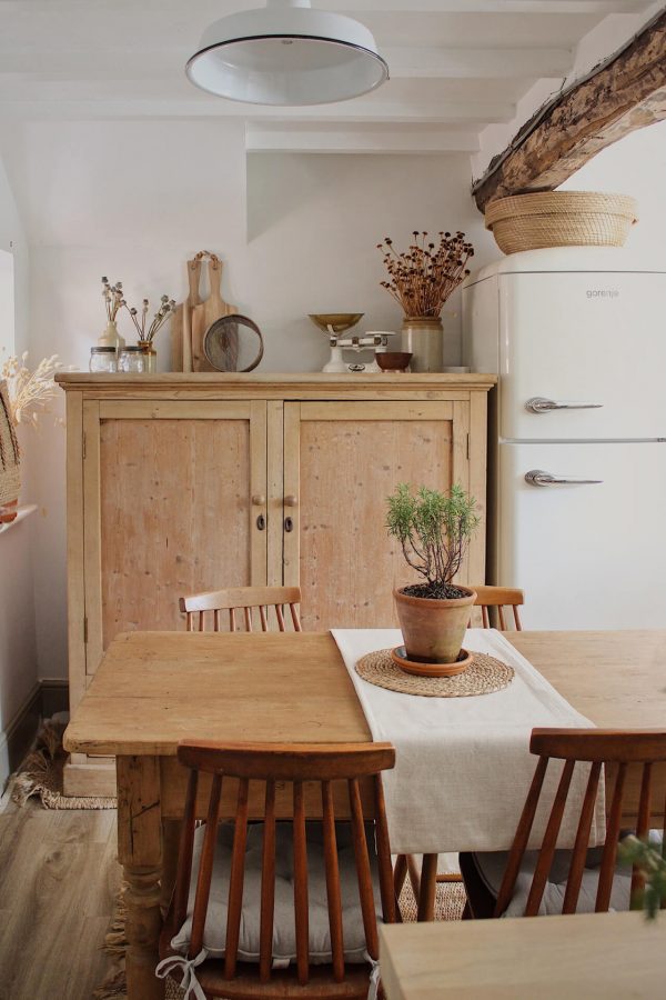 Home tour with Rachel Ashfield of @the_old_cottage - old wooden furniture in a kitchen with vintage finds decorating the surfaces.
