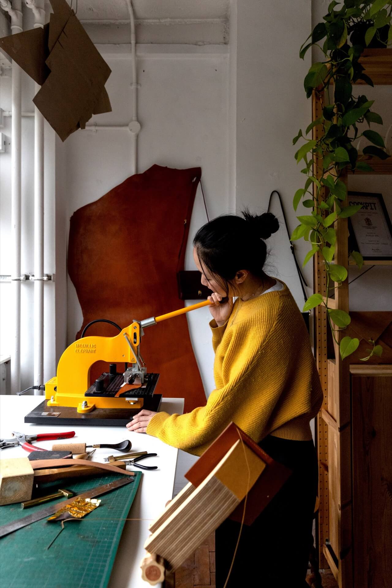 Michelle Wong inside the MW Makes studio creating handcrafted leather goods